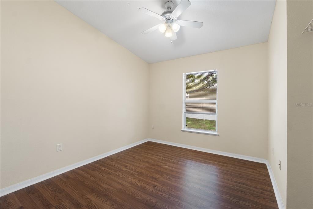 2339 Foxtree Road Tavares, FL 32778 - Photo 24 of 36 an empty room with wooden floor closet and fan
