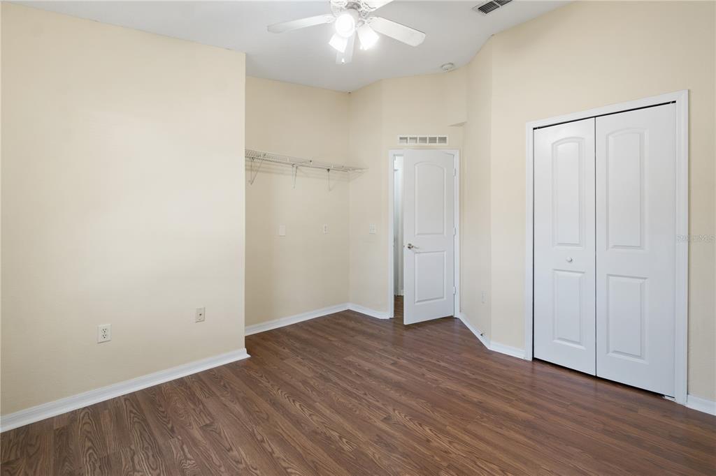 2339 Foxtree Road Tavares, FL 32778 - Photo 25 of 36 an empty room with wooden floor and a ceiling fan