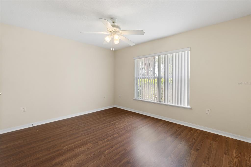 2339 Foxtree Road Tavares, FL 32778 - Photo 28 of 36 a view of an empty room with wooden floor and a window