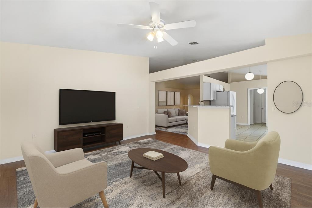 2339 Foxtree Road Tavares, FL 32778 - Photo 5 of 36 a living room with furniture a rug and a flat screen tv