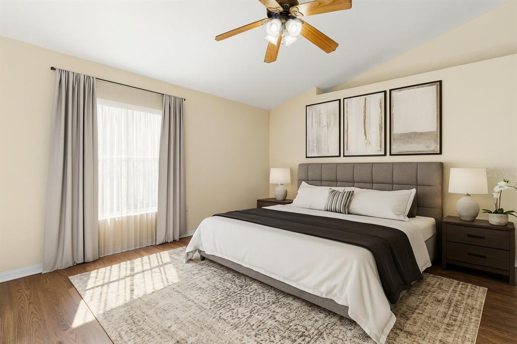 2339 Foxtree Road Tavares, FL 32778 - Photo 6 of 36 a bedroom with a bed and a chandelier