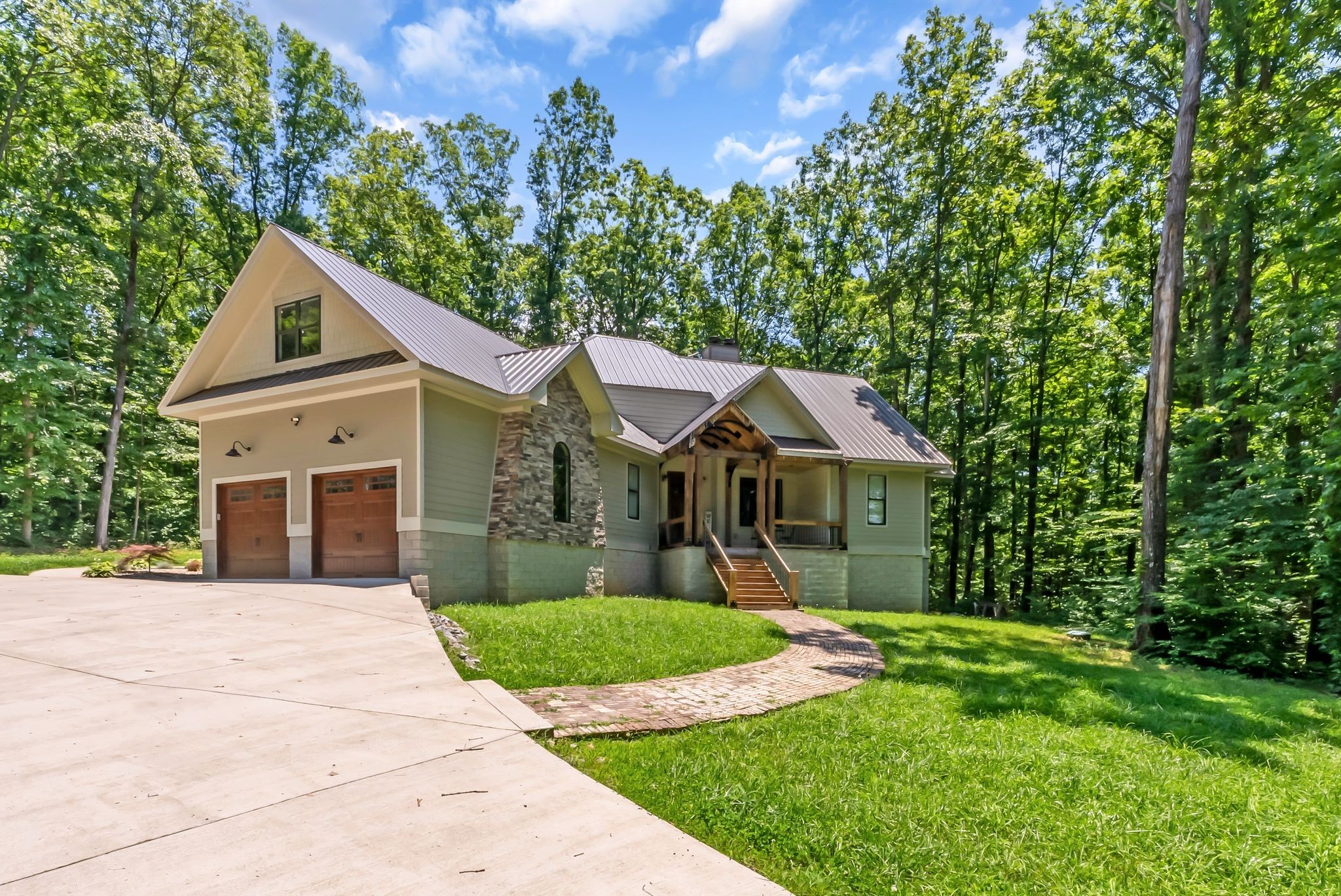 7890 Oscar Green Road Primm Springs, TN 38476 - Photo 1 of 52 a front view of a house with a yard and trees