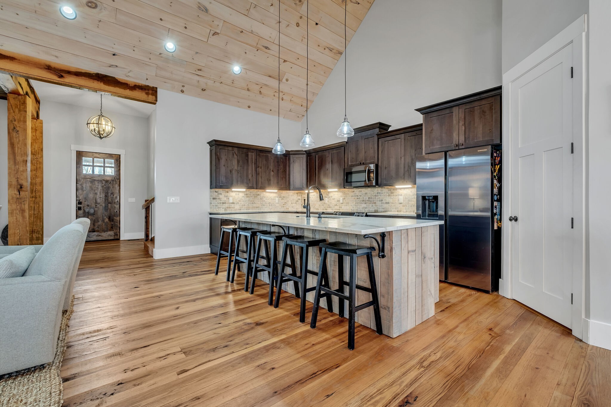 7890 Oscar Green Road Primm Springs, TN 38476 - Photo 16 of 52 a kitchen with stainless steel appliances granite countertop a refrigerator a stove a sink dishwasher a oven with white cabinets and wooden floor