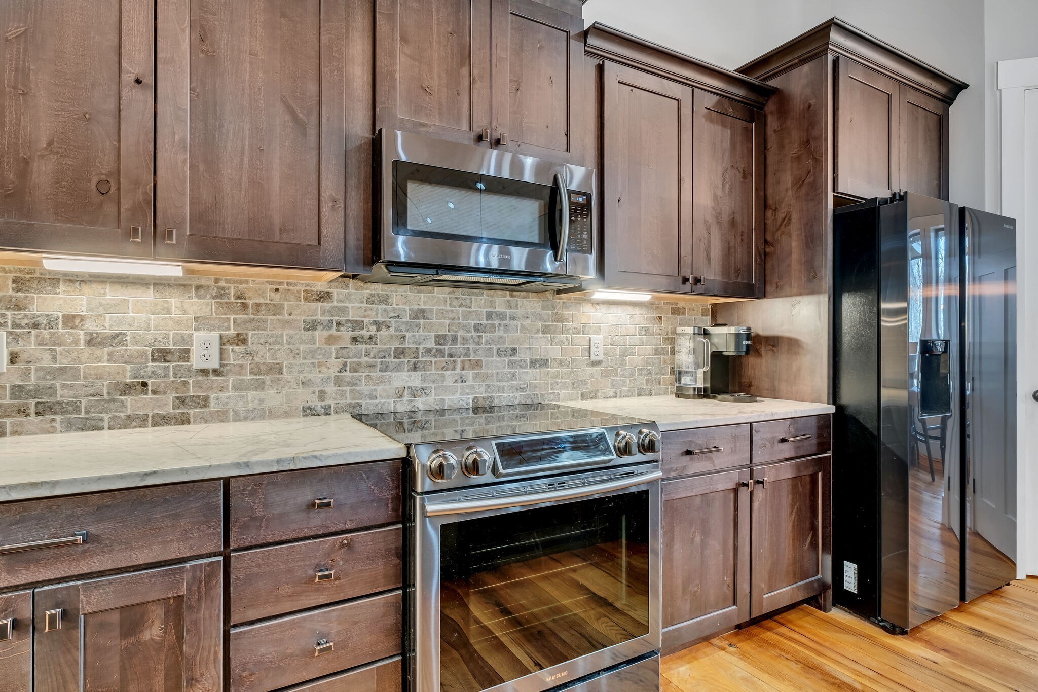 7890 Oscar Green Road Primm Springs, TN 38476 - Photo 17 of 52 a kitchen with stainless steel appliances a stove and a refrigerator