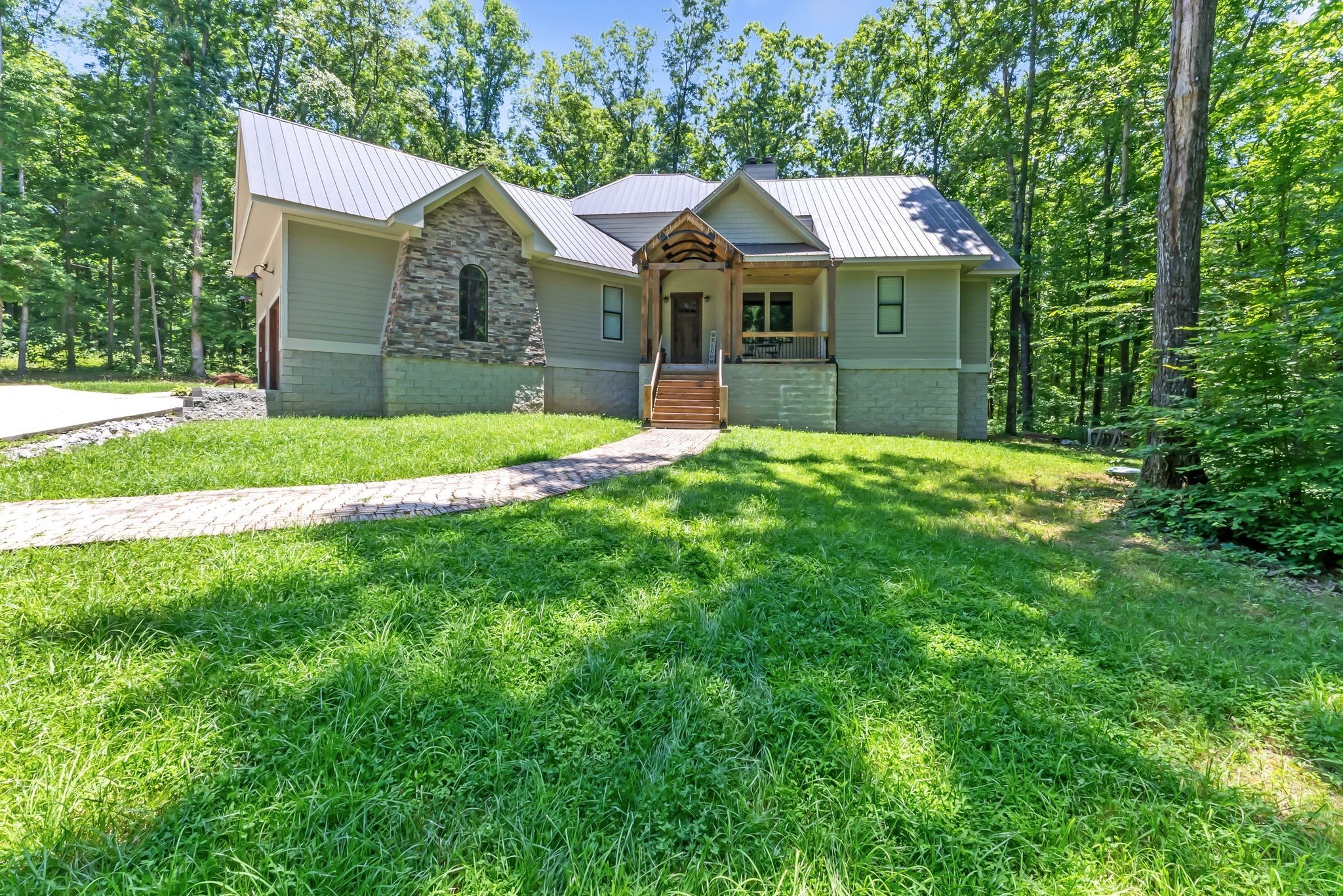 7890 Oscar Green Road Primm Springs, TN 38476 - Photo 2 of 52 a front view of a house with a yard and trees