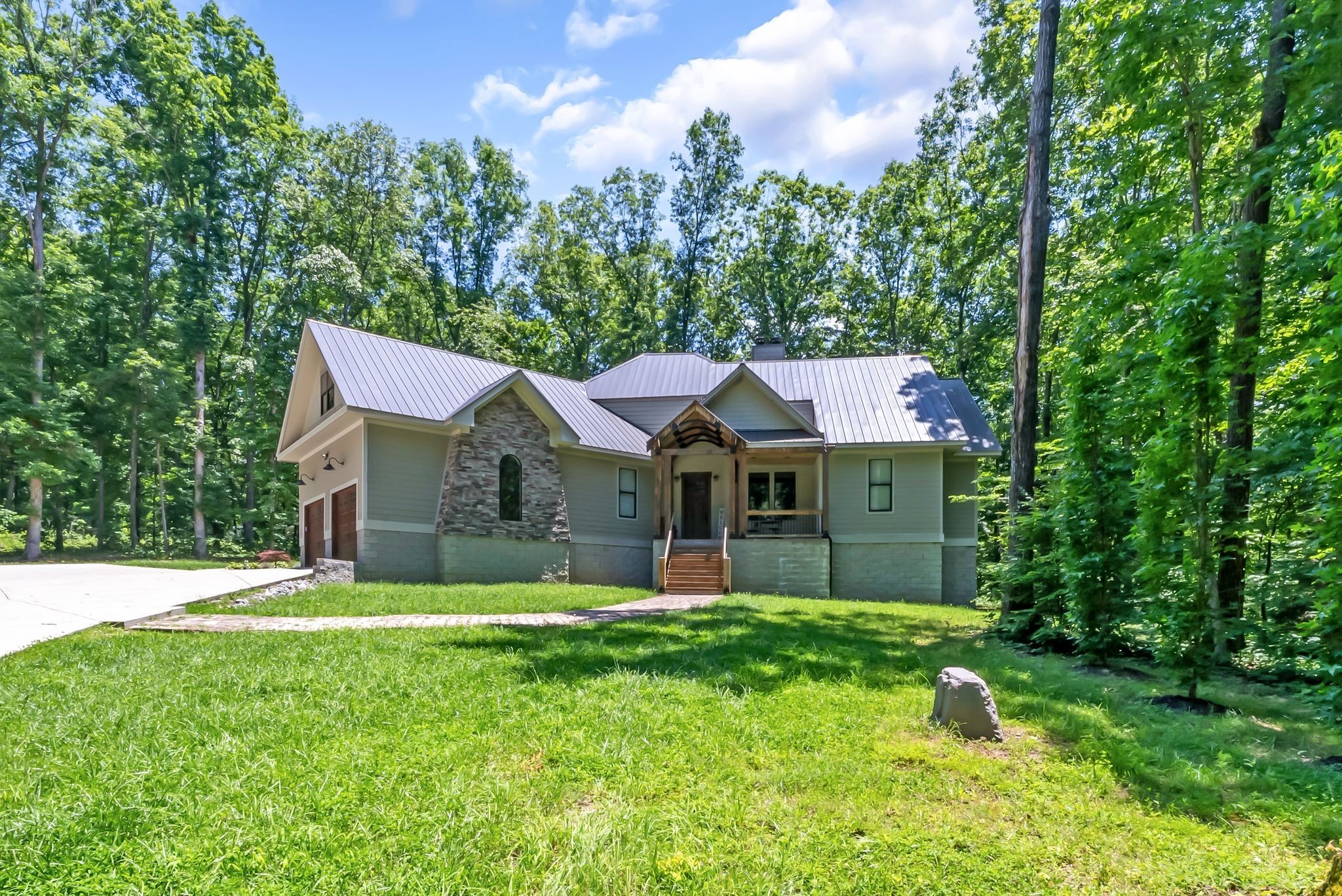7890 Oscar Green Road Primm Springs, TN 38476 - Photo 50 of 52 a front view of a house with garden