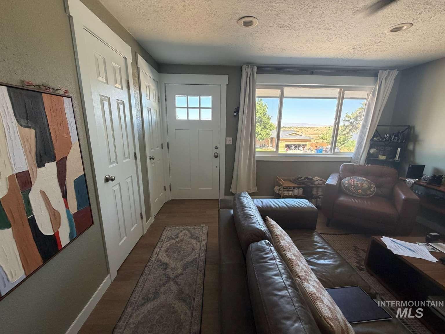 9951 West Fox Ridge Drive Boise, ID 83709 - Photo 6 of 13 Entryway with wood-finish flooring and multiple paneled doors
