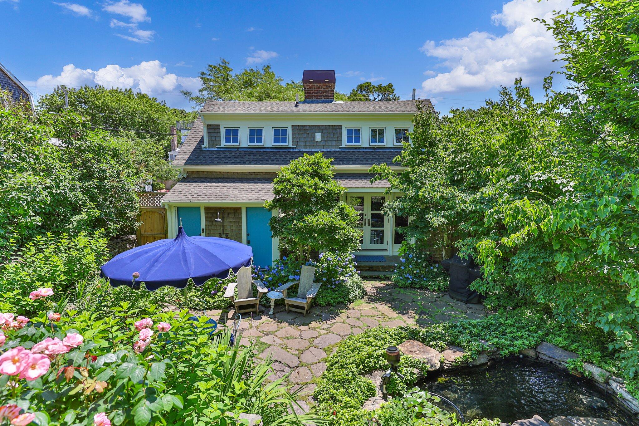 260 Bradford Street Provincetown, MA 02657 - Photo 1 of 42 a view of a house with a yard and sitting area
