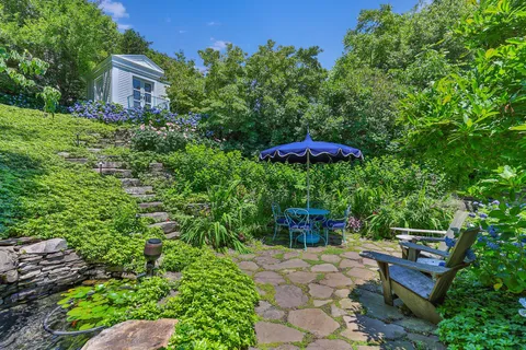 a backyard of a house with a yard and outdoor seating