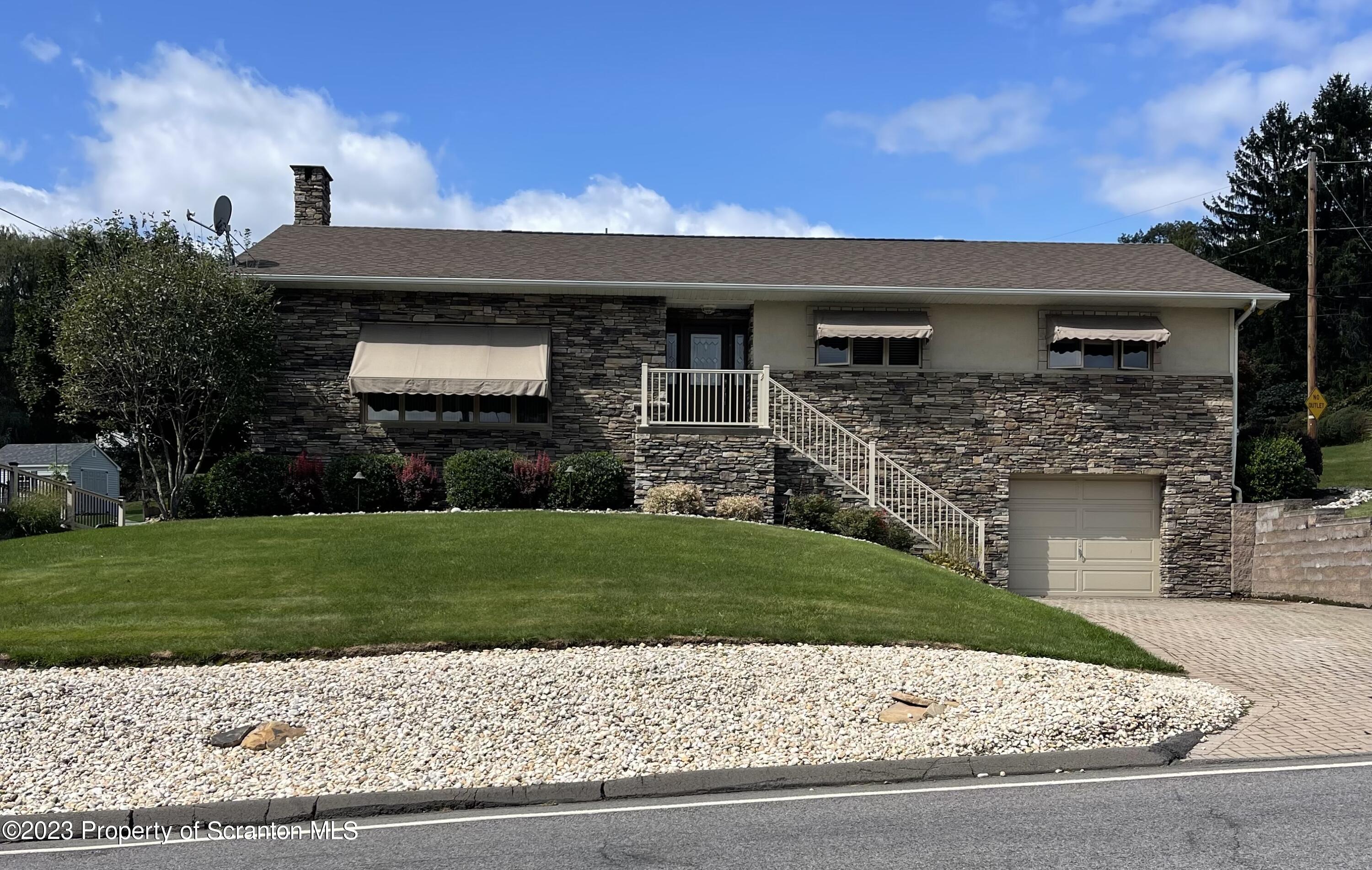 225 Main Street Olyphant, PA 18447 - Photo 1 of 60 a front view of a house with a garden
