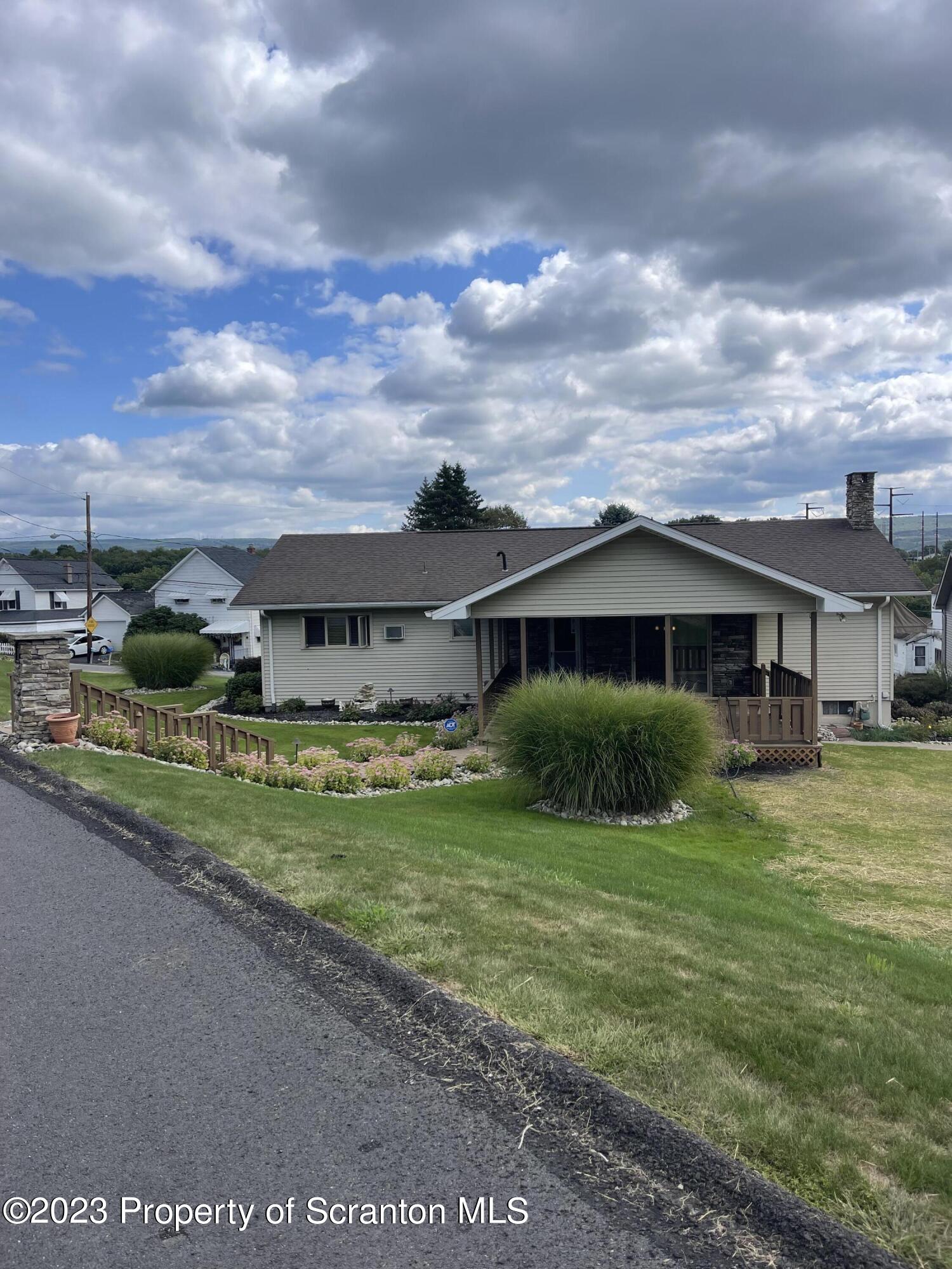 225 Main Street Olyphant, PA 18447 - Photo 14 of 60 a front view of a house with garden