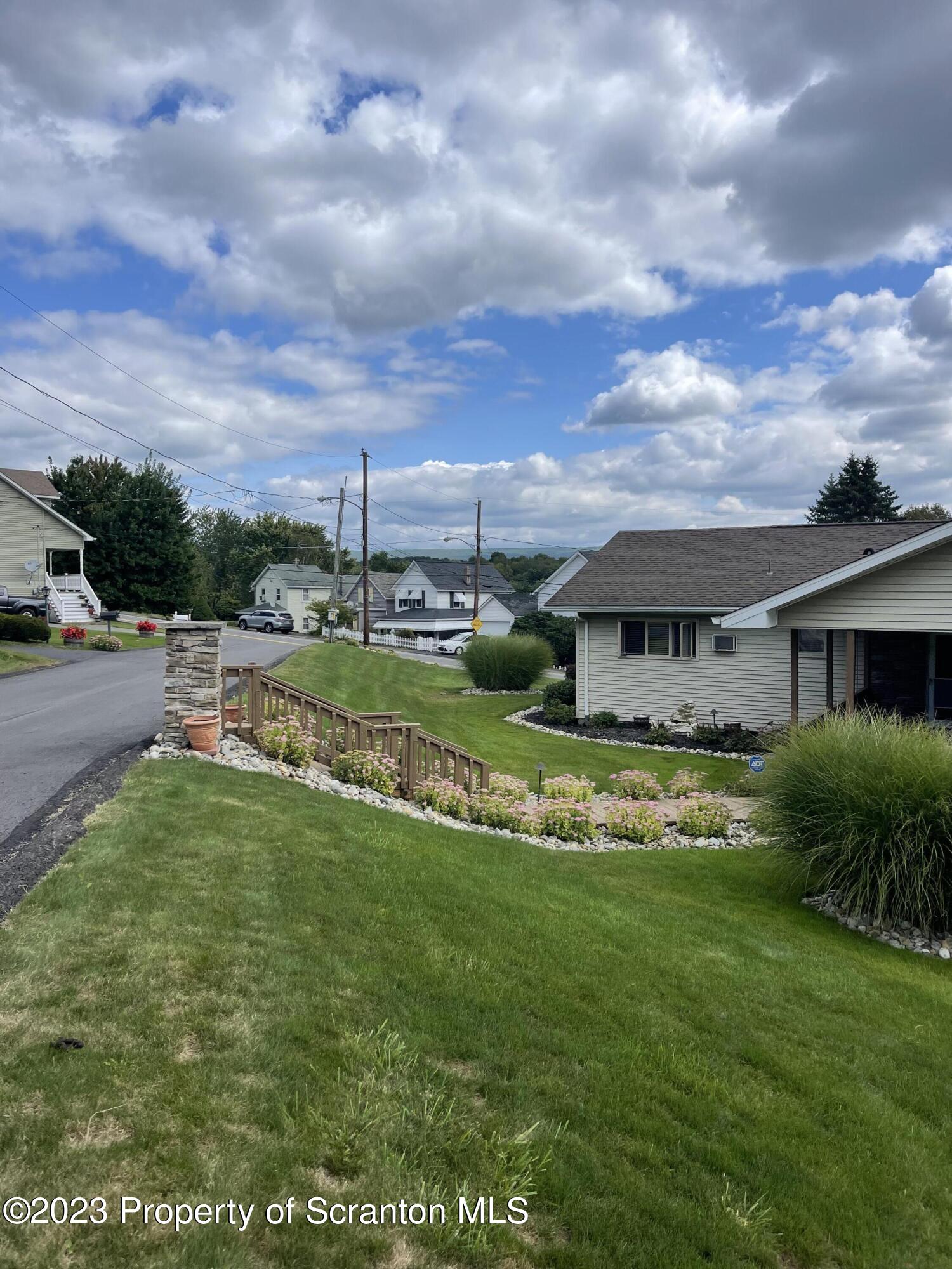 225 Main Street Olyphant, PA 18447 - Photo 15 of 60 a view of a house with a big yard plants and large trees