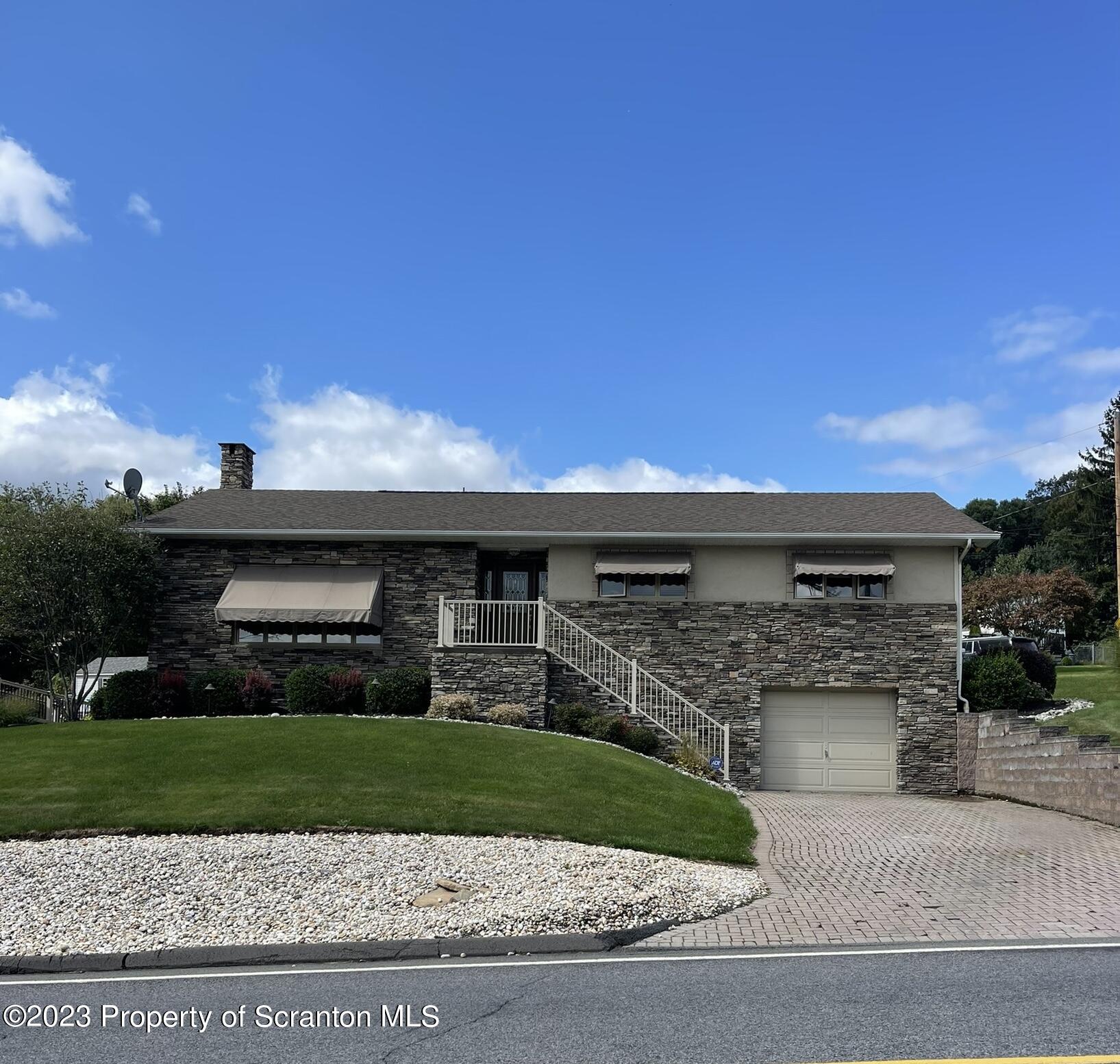 225 Main Street Olyphant, PA 18447 - Photo 2 of 60 a front view of a house with a yard