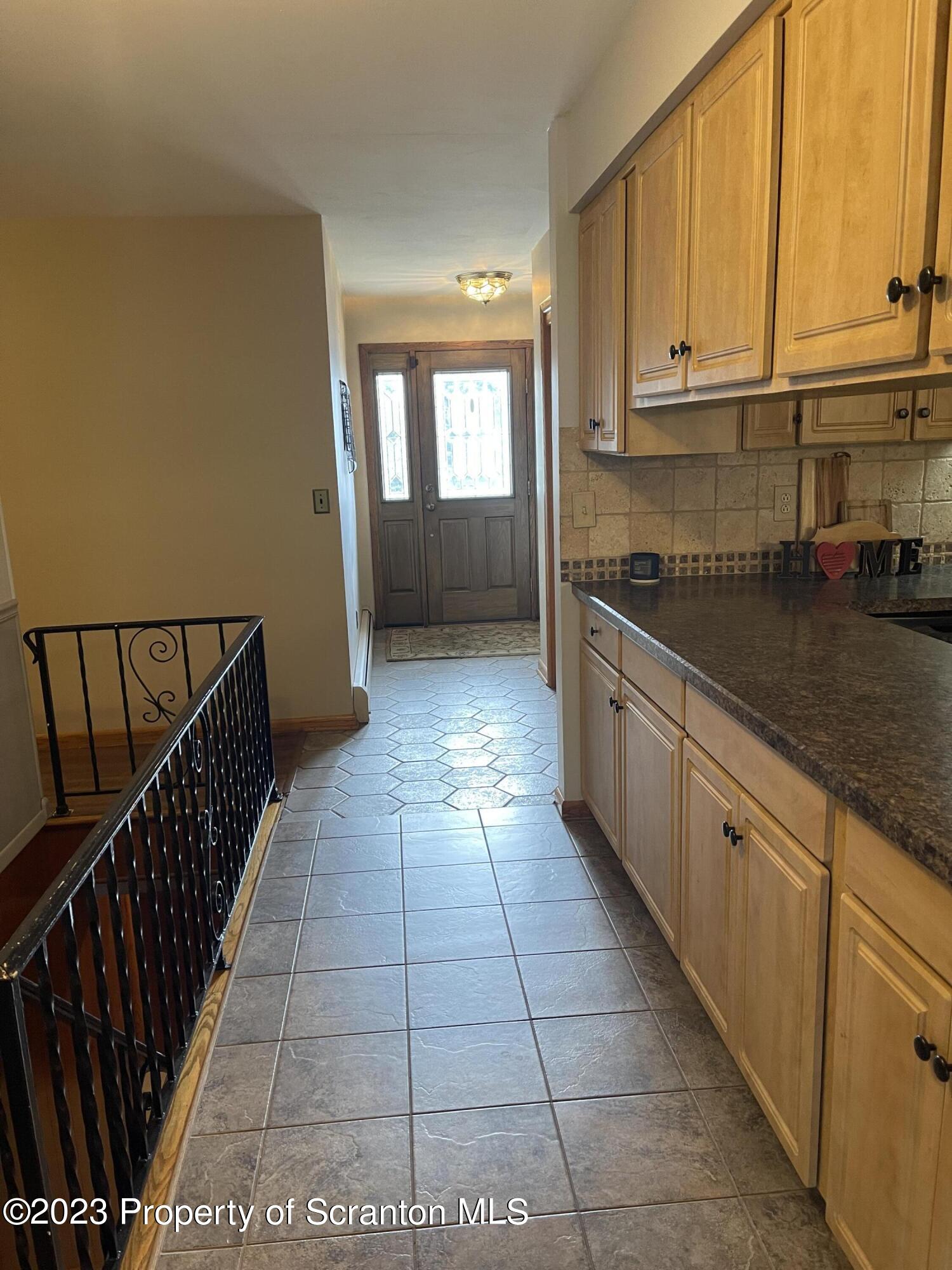 225 Main Street Olyphant, PA 18447 - Photo 24 of 60 a kitchen with granite countertop a stove a sink and dishwasher