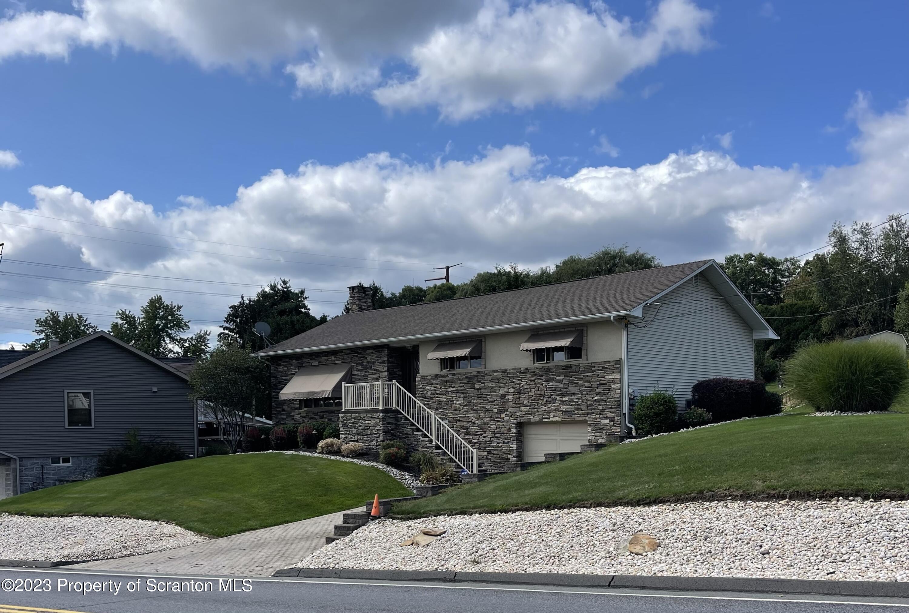 225 Main Street Olyphant, PA 18447 - Photo 3 of 60 a front view of a house with a garden