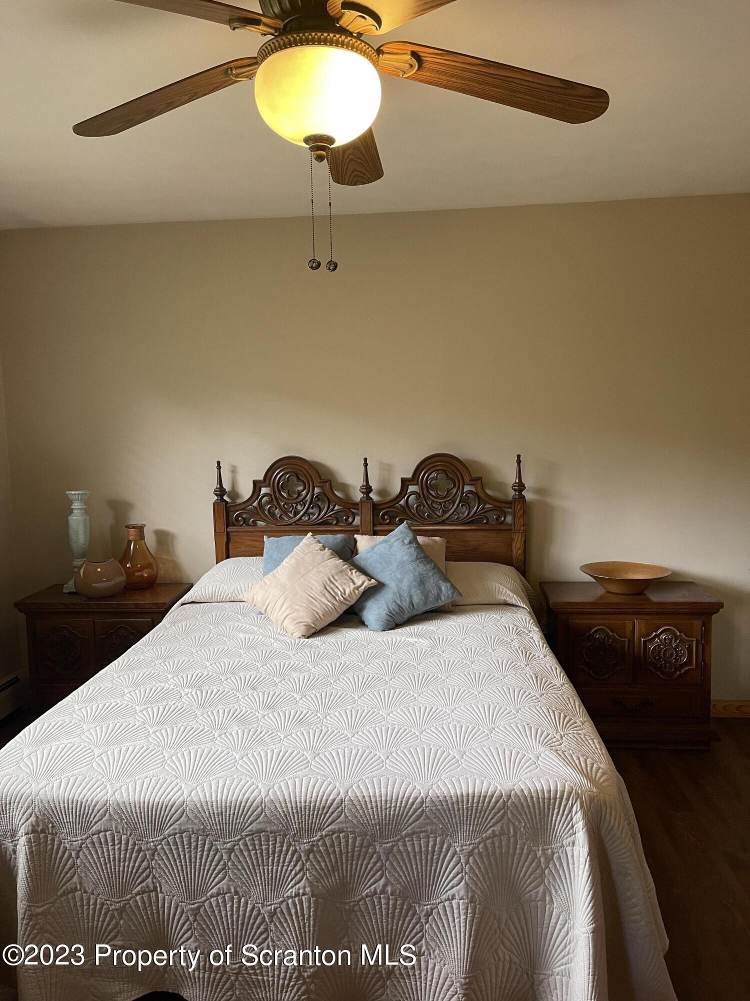 225 Main Street Olyphant, PA 18447 - Photo 31 of 60 a bedroom with a bed and lamps