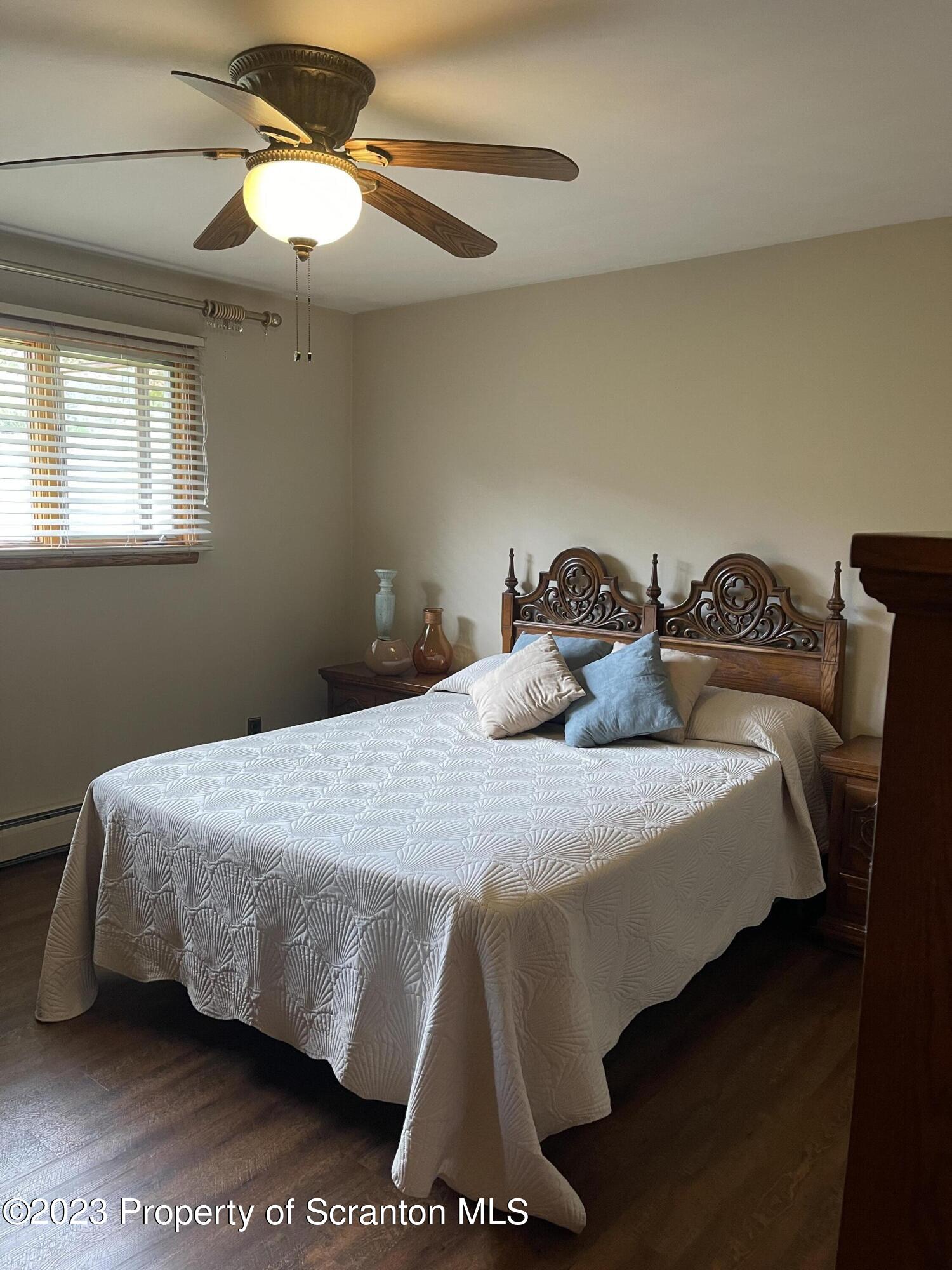 225 Main Street Olyphant, PA 18447 - Photo 34 of 60 a bedroom with a bed and a chandelier