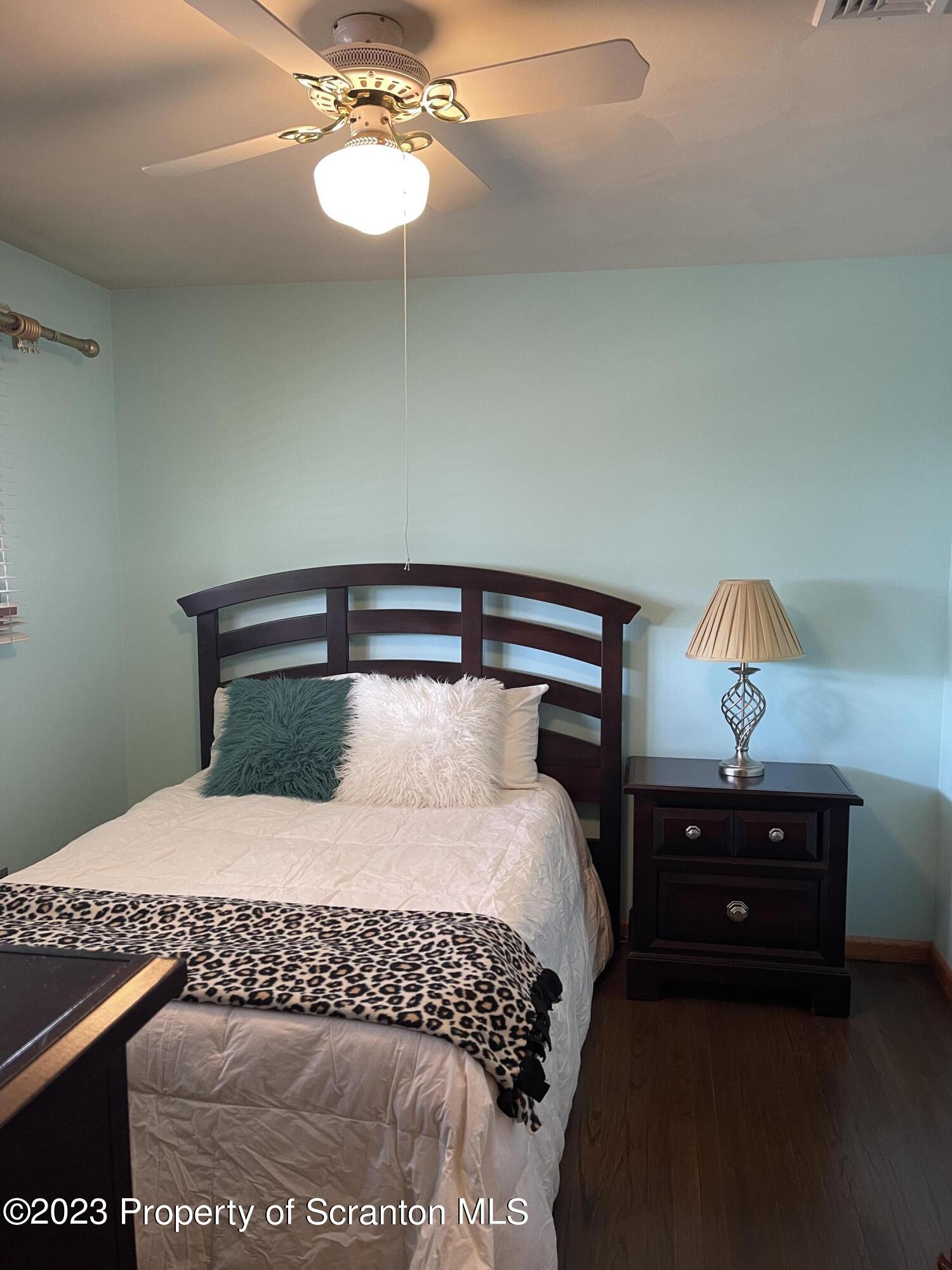 225 Main Street Olyphant, PA 18447 - Photo 36 of 60 a bedroom with a bed and a lamp