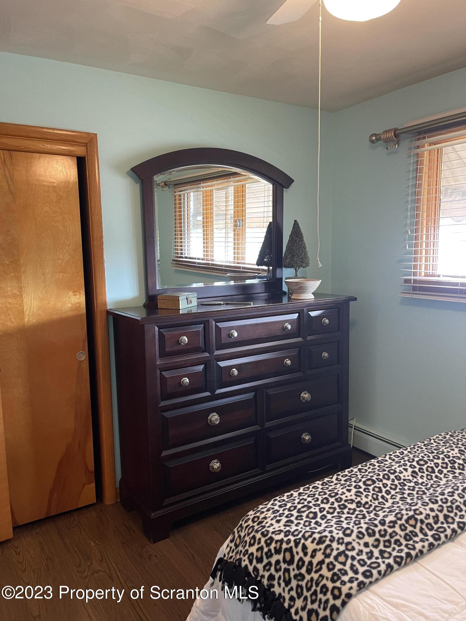 225 Main Street Olyphant, PA 18447 - Photo 37 of 60 a room with a dresser with a mirror