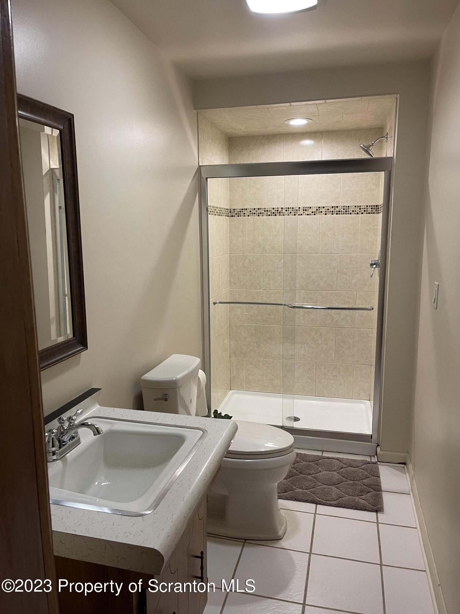 225 Main Street Olyphant, PA 18447 - Photo 44 of 60 a bathroom with a sink a toilet and shower