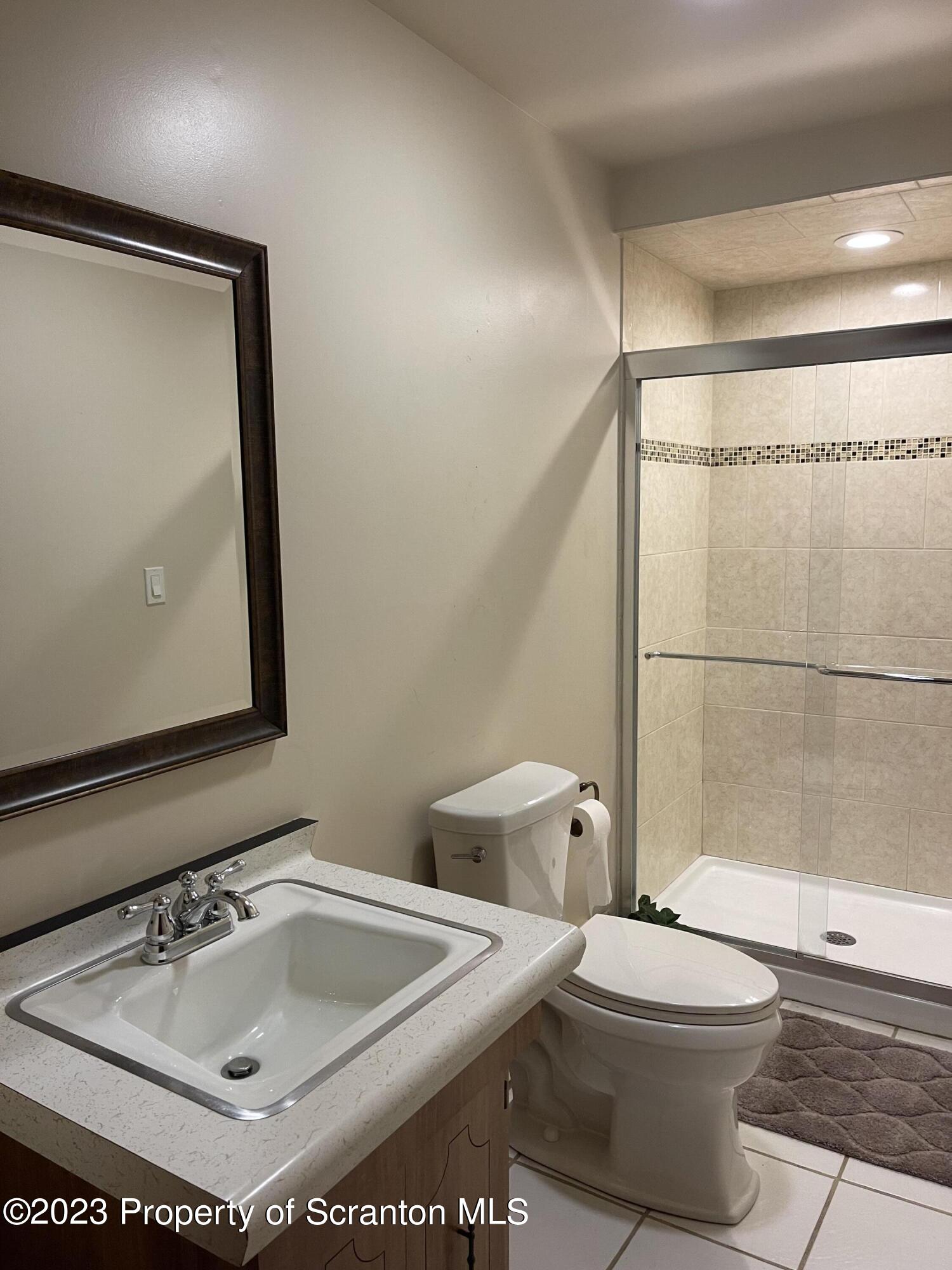 225 Main Street Olyphant, PA 18447 - Photo 45 of 60 a bathroom with a sink toilet and shower