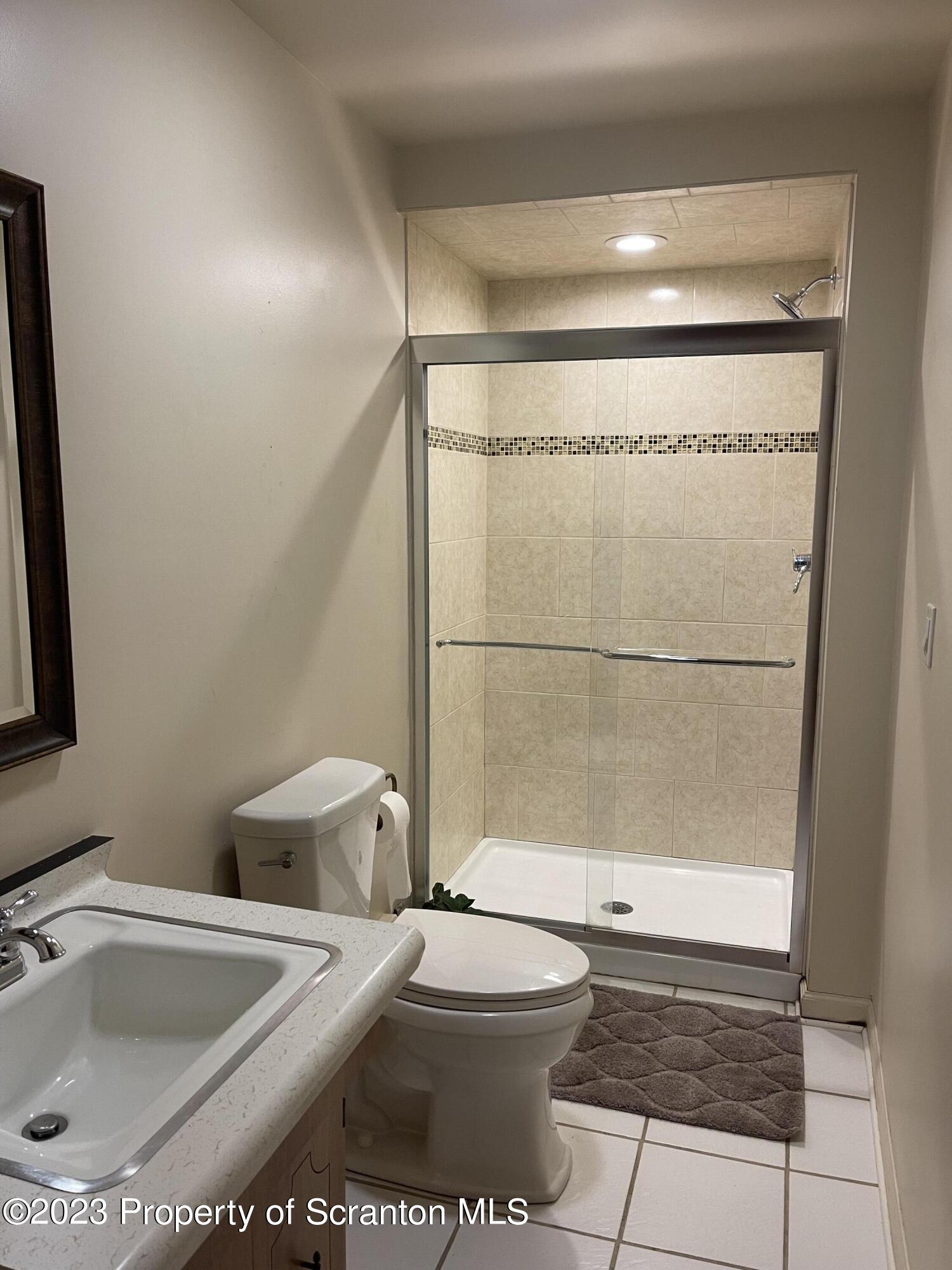 225 Main Street Olyphant, PA 18447 - Photo 46 of 60 a bathroom with a toilet a sink and a shower