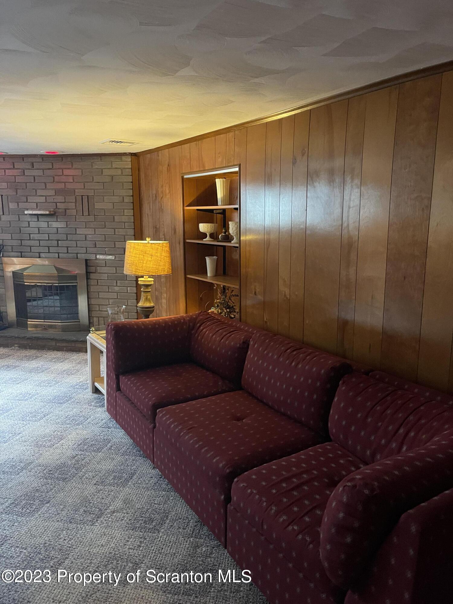 225 Main Street Olyphant, PA 18447 - Photo 50 of 60 a living room with a couch and a fireplace