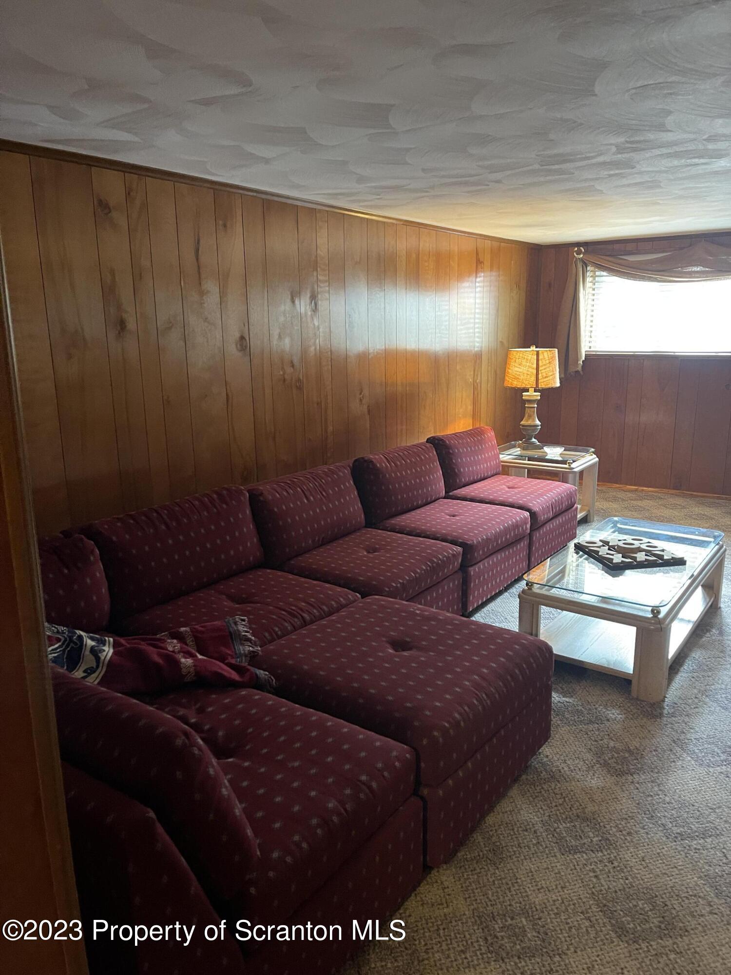 225 Main Street Olyphant, PA 18447 - Photo 51 of 60 a living room with furniture and a lamp