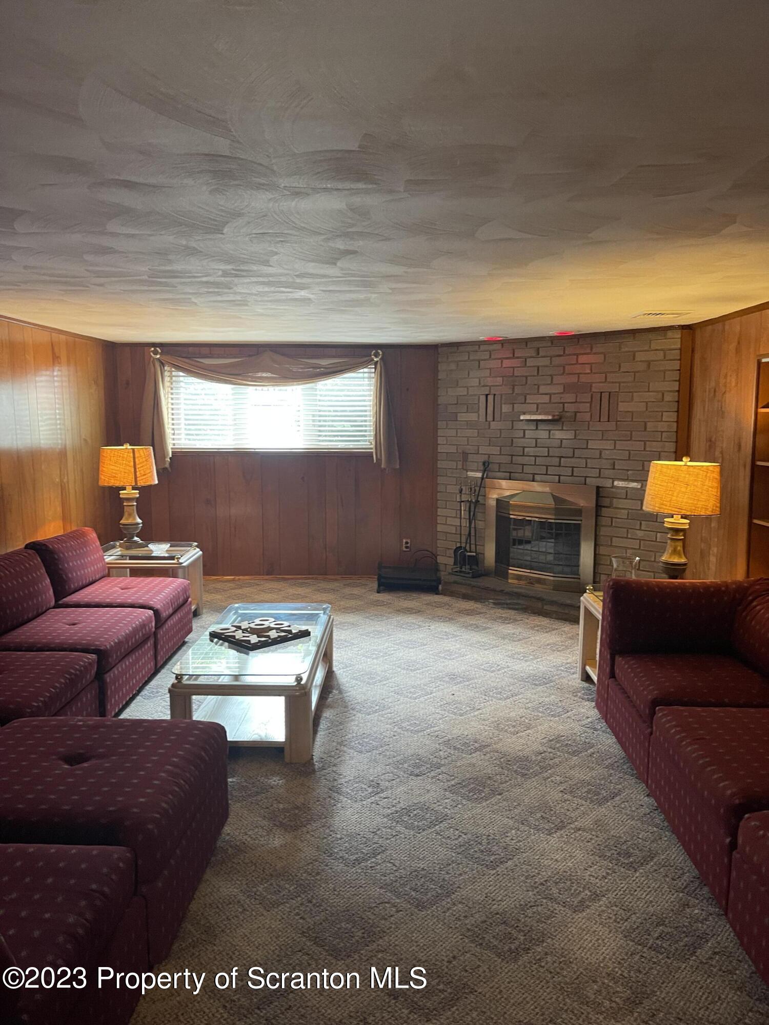 225 Main Street Olyphant, PA 18447 - Photo 52 of 60 a living room with furniture and a fireplace