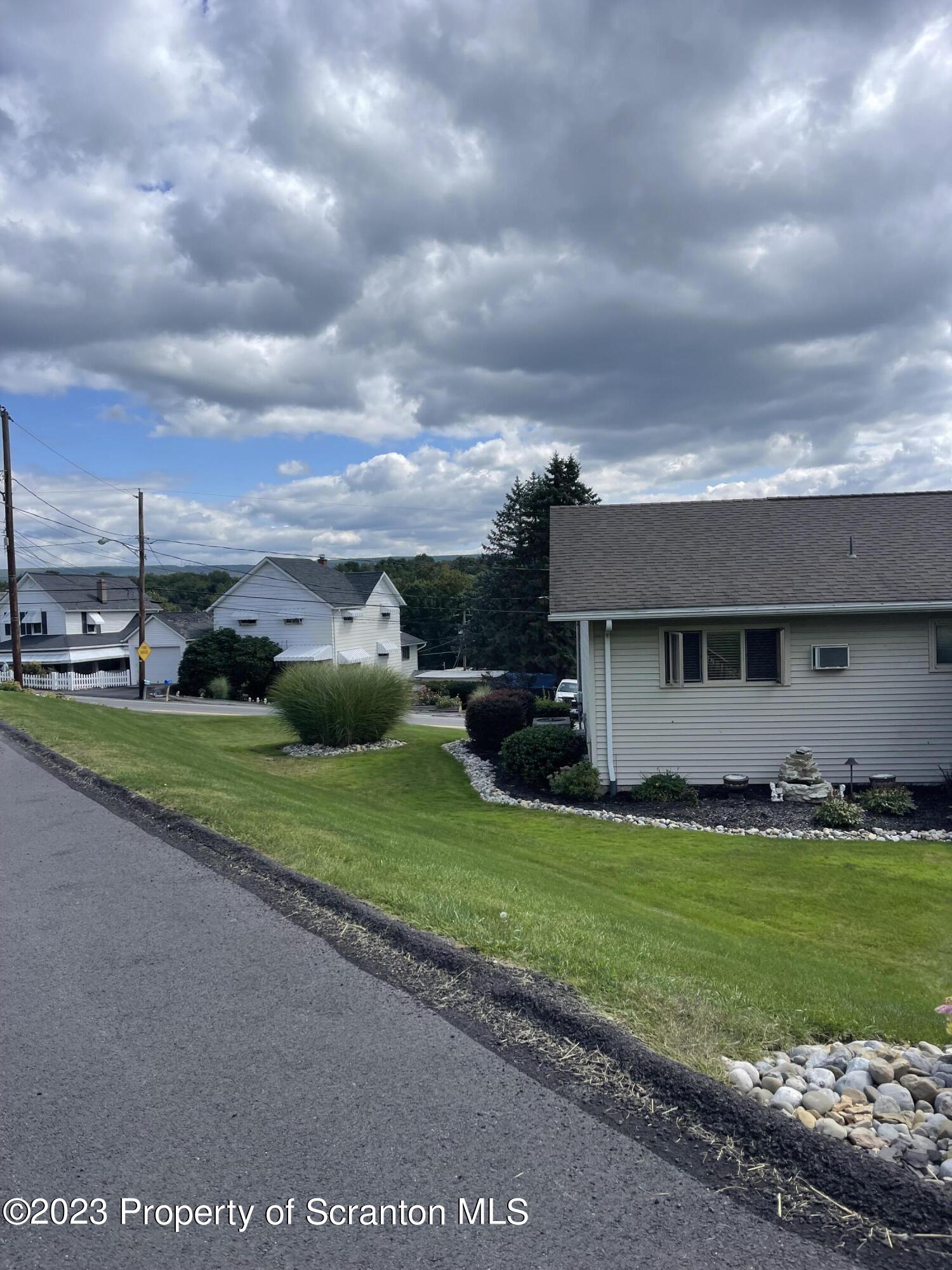 225 Main Street Olyphant, PA 18447 - Photo 8 of 60 a view of a house with a yard and garage