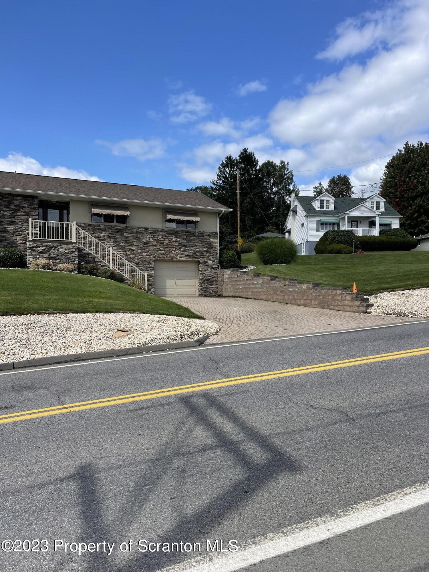 225 Main Street Olyphant, PA 18447 - Photo 9 of 60 a view of a street with a building in the background