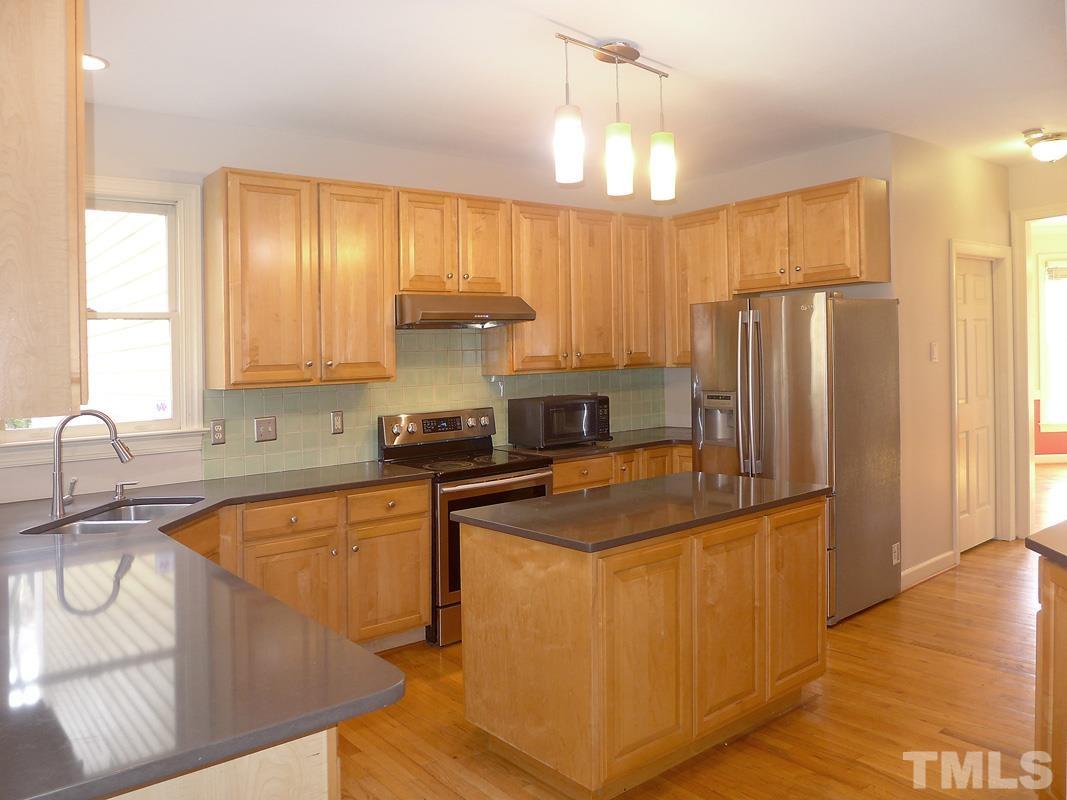 2003 Whitmore Circle Chapel Hill, NC 27516 - Photo 13 of 35 a kitchen with stainless steel appliances granite countertop a sink a stove and a refrigerator