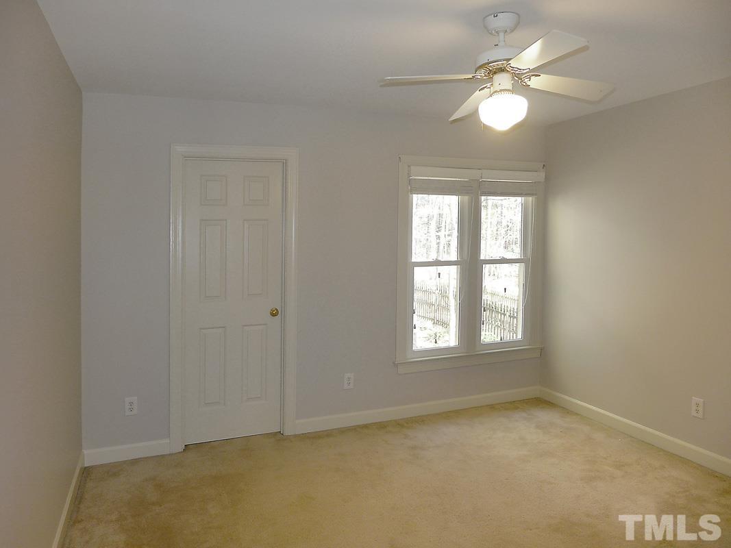 2003 Whitmore Circle Chapel Hill, NC 27516 - Photo 28 of 35 an empty room with window chandelier fan and windows