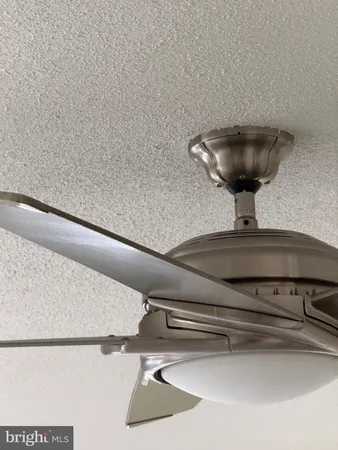 a room with water heater and wooden cabinets