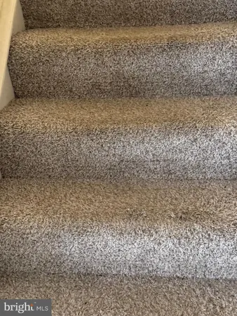 a view of staircase with white walls
