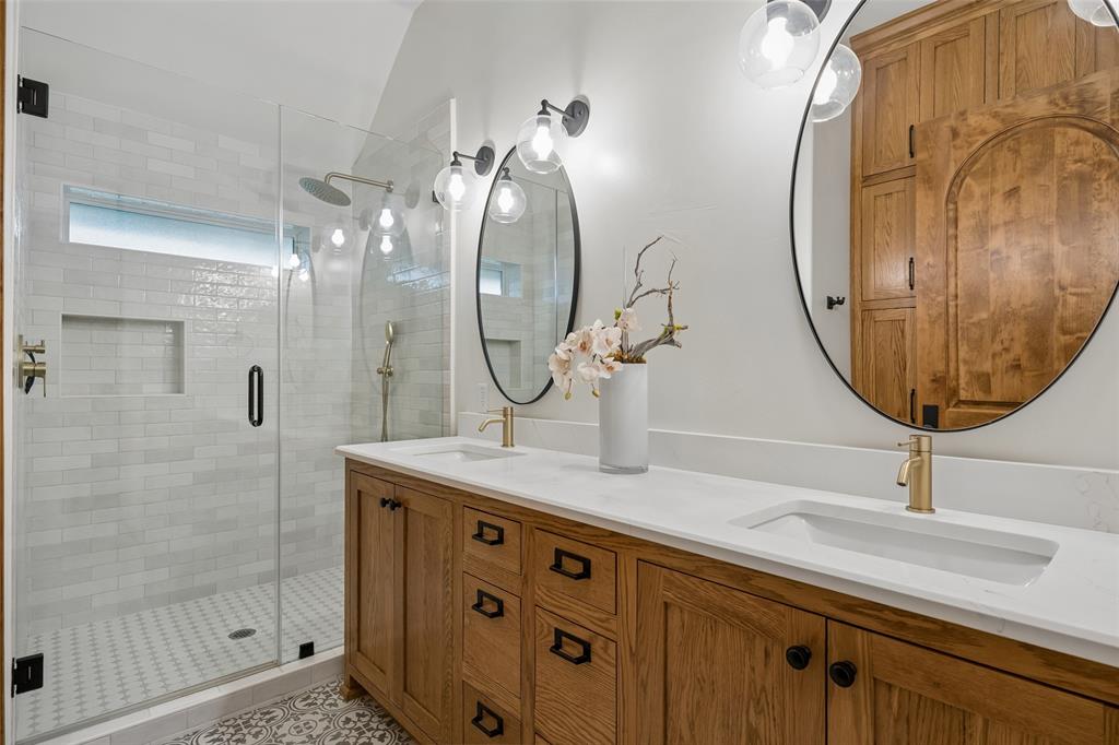 1620 Timber Ridge Lane Keller, TX 76262 - Photo 22 of 40 This beautifully appointed bathroom features a custom wood vanity topped with a sleek quartz countertop, designer lighting, and elegant brass fixtures