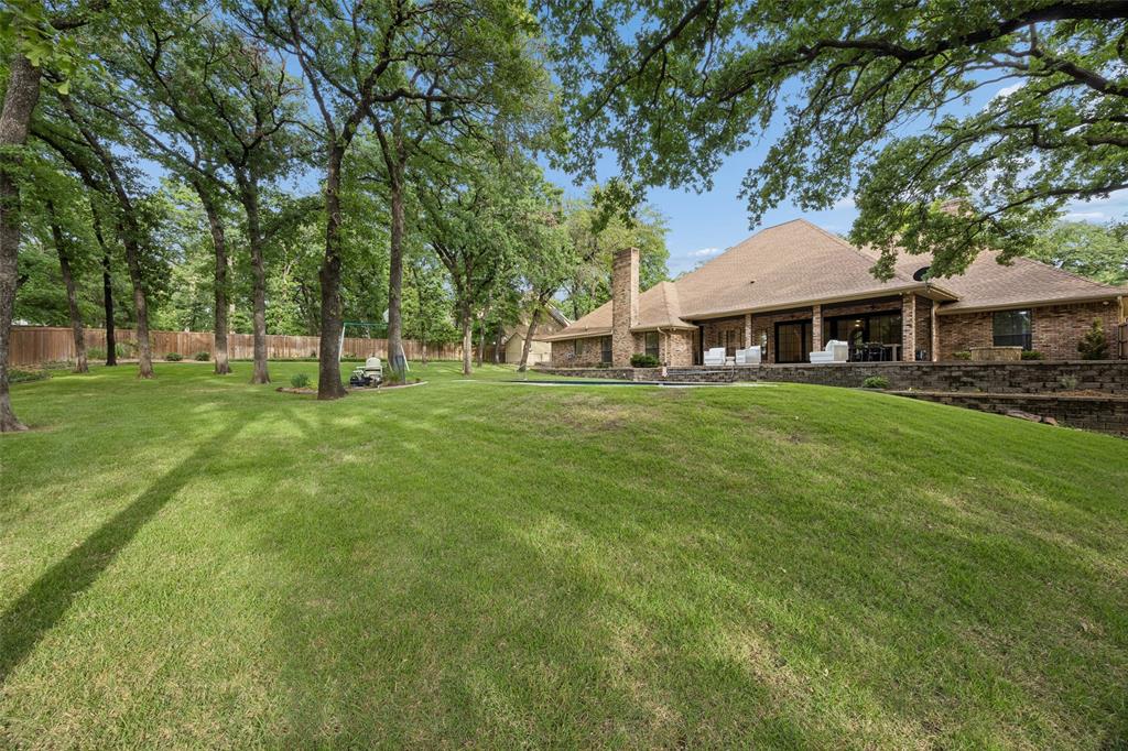 1620 Timber Ridge Lane Keller, TX 76262 - Photo 35 of 40 The backyard offers a rare combination of privacy, open green space, and natural beauty