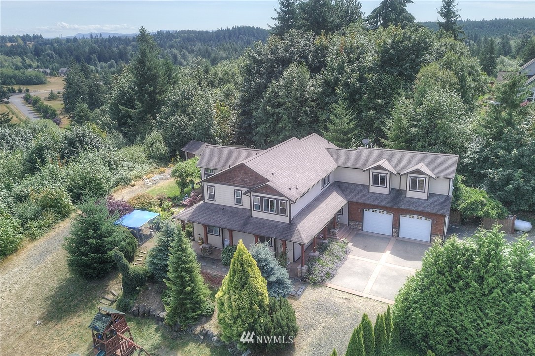 6110 139th Court Southwest Rochester, WA 98579 - Photo 1 of 36 an aerial view of a house with a yard and a large tree