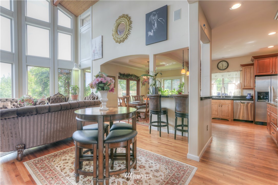 6110 139th Court Southwest Rochester, WA 98579 - Photo 4 of 36 a dining room with wooden floor and large windows