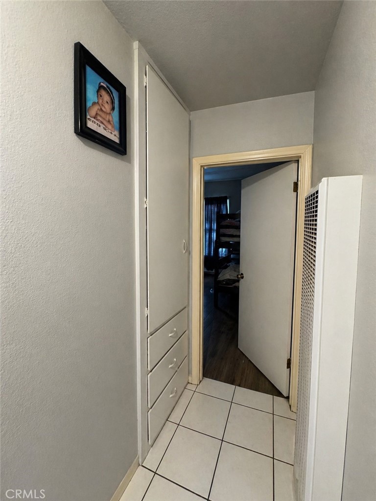 3904 Monroe Street Riverside, CA 92503 - Photo 10 of 22 a hallway with cabinets and a refrigerator