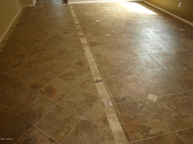 a bathroom with a granite countertop sink a mirror and a shower