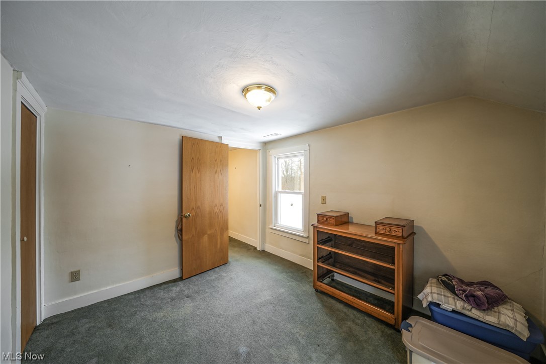 7541 Cooley Road Ravenna, OH 44266 - Photo 20 of 32 Bedroom with dark carpet and vaulted ceiling