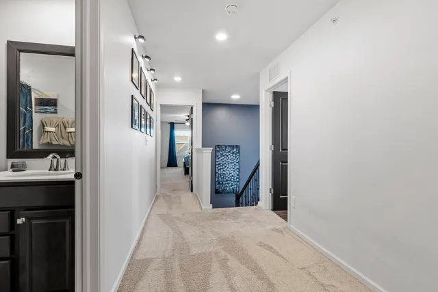 a view of a hallway and a livingroom with a bathroom