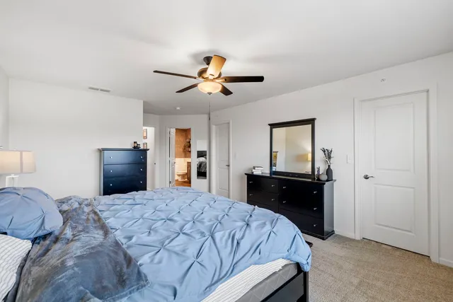 a bedroom with a bed and a chandelier