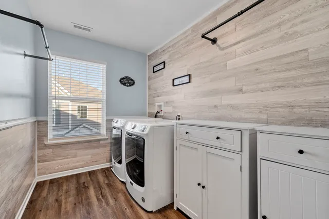 a utility room with cabinets dryer and washer