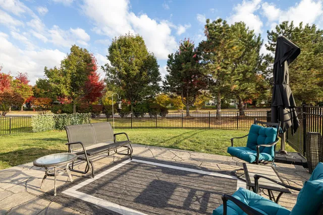 a view of a swimming pool and lounge chairs in back yard