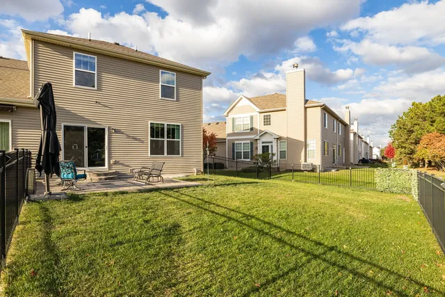 a view of a house with swimming pool and sitting area
