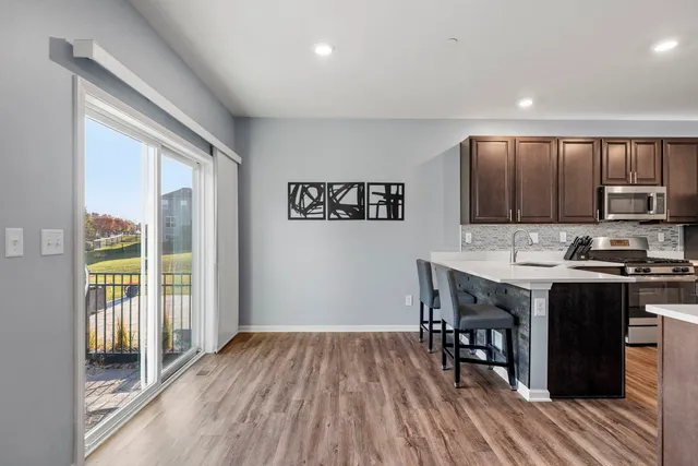 a kitchen with wooden floors and wooden cabinets