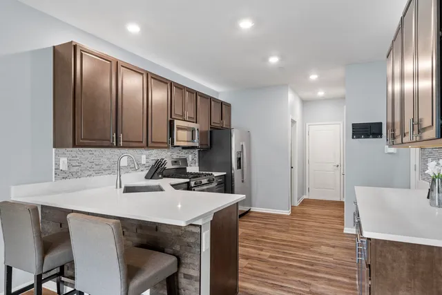 a kitchen with a sink cabinets and wooden floor
