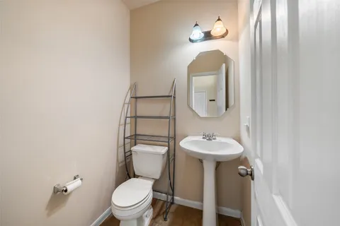 a kitchen with a refrigerator a stove a sink dishwasher with a dining table and chairs